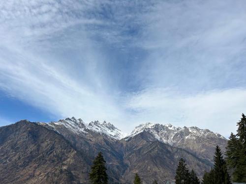 a view of a mountain range with snow covered mountains at Golden Luck MANN CAFE in Kalgha