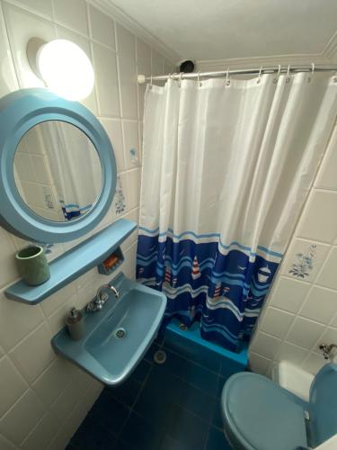 a bathroom with a sink and a mirror and a toilet at Valerie's House in Poros