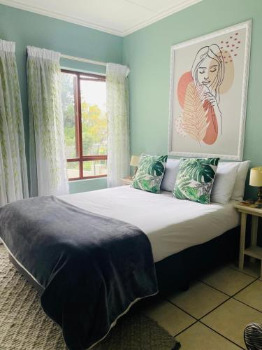 a bedroom with a large bed with a window at 361 On Sunset in Sandton