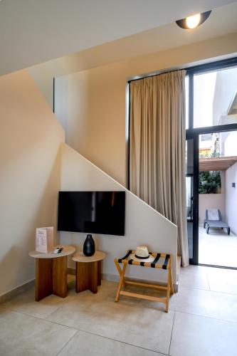 a living room with a flat screen tv at Marni Village in Hersonissos