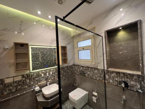 a bathroom with a toilet and a sink at Elite hotel in Sheikh Zayed