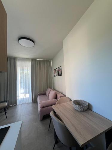 a living room with a couch and a table at ALTHEA luxury suites and apartments in Plataria