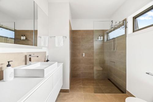 a white bathroom with a sink and a shower at Station House - Mansfield - Sleeps 8 in Mansfield