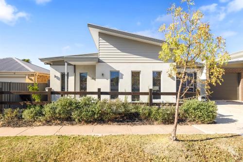 a house with a tree in front of it at Station House - Mansfield - Sleeps 8 in Mansfield