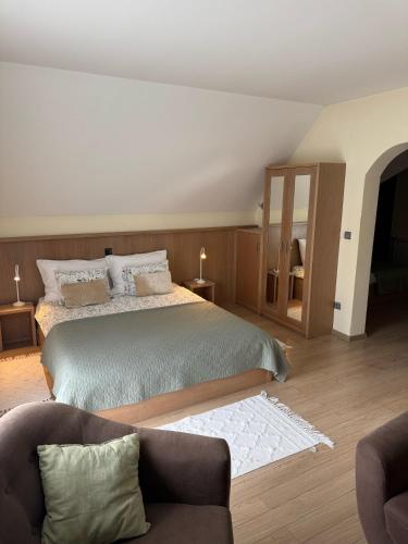 a bedroom with a bed and a couch at House Biba & Leona in Rastovača