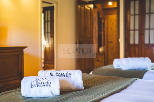 a hotel room with two beds with towels on them at El Balcón Del Profesor By Silastur in Cereceda