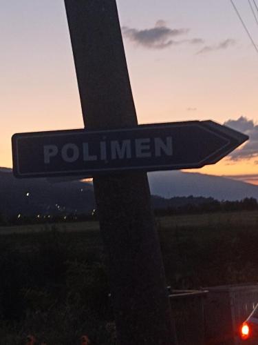 a street sign with the word pollution on it at Bujtina Polimen in Përmet