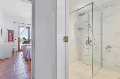 a bathroom with a shower with a glass door at 4 bedroom Villa Helidoni with private infinity pool, Aphrodite Hills Resort in Kouklia