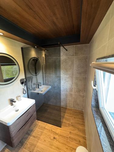 a bathroom with a sink and a shower at House Biba & Leona in Rastovača