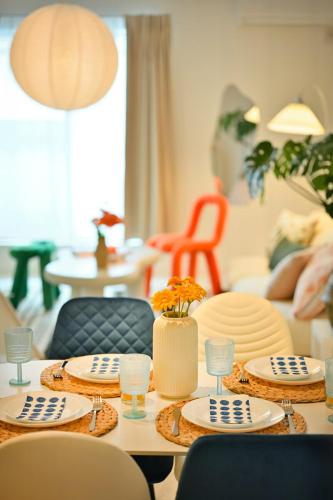 a living room with a table with plates and chairs at Otter Stay - Kogane in Nagoya