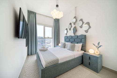 a bedroom with a large bed and a tv at Airstay - Sophisticated 2BR - Dubai Hills Estate - Monthly Offer Available in Dubai