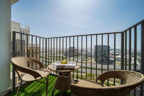 a table and chairs on a balcony with a view at Airstay - Sophisticated 2BR - Dubai Hills Estate - Monthly Offer Available in Dubai