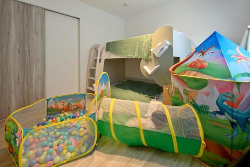 a childs room with a play bed and a play tent at Otter Stay - Kogane in Nagoya