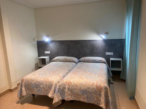 Postel nebo postele na pokoji v ubytování Hostal Retiro