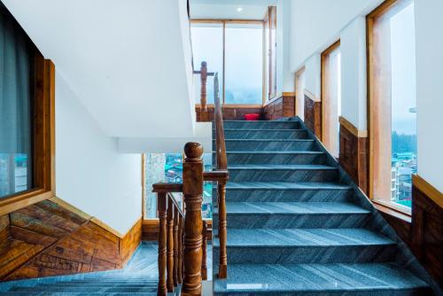 a stairway in a building with a view at Treebo Premium Sattva With Mountain View in Manāli