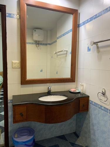 a bathroom with a sink and a mirror at Riverhome Saigon Apartments in Ho Chi Minh City