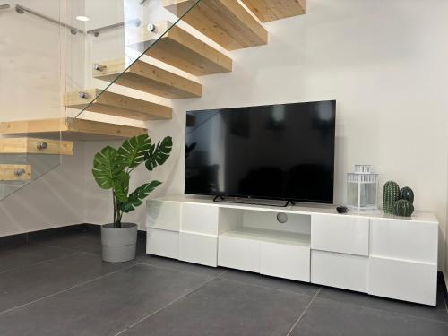 a living room with a tv on a white wall at Cortiletto Pavone A in Catania