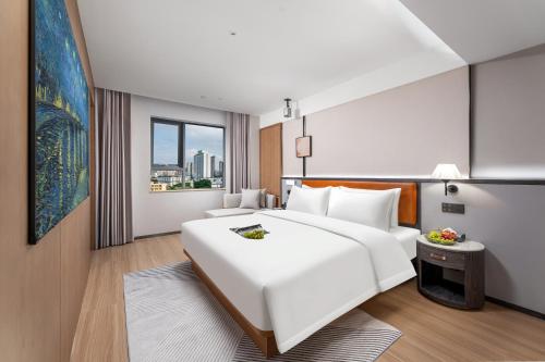 Postel nebo postele na pokoji v ubytování Dingshe Hotel Guangzhou Shamian Island Yongqingfang Branch