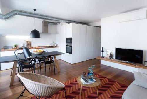 a kitchen and living room with a table and chairs at Design in Liberdade - 2 bedroom Apartment, Marquês Pombal in Lisbon