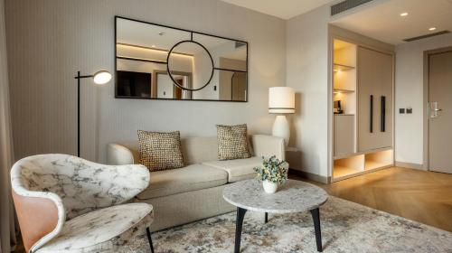 a living room with a couch and a table at Ilunion Málaga in Málaga
