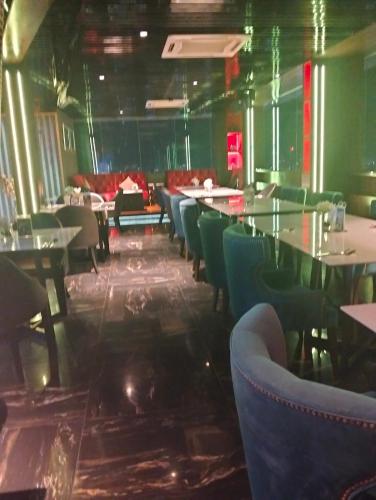 a restaurant with tables and chairs in a room at KLCC Suites At Platinum By MiM in Kuala Lumpur