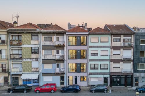 a group of buildings with cars parked in a parking lot at HostWise - Premium & Modern Building in Porto