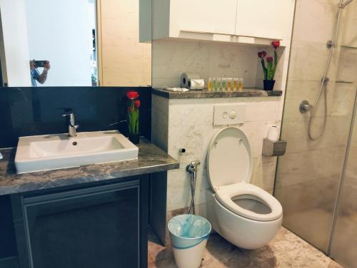 a bathroom with a toilet and a sink at KLCC Suites At Platinum By MiM in Kuala Lumpur