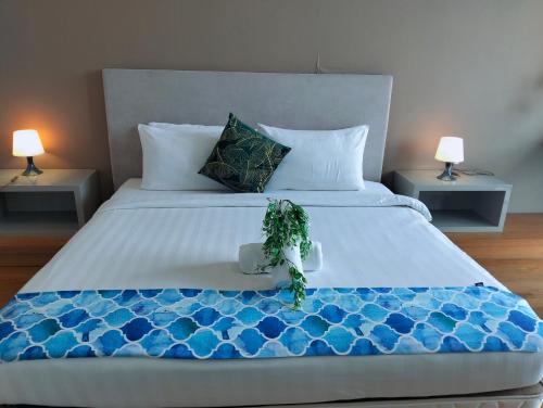 a bedroom with a large bed with two lamps at KLCC Suites At Platinum By MiM in Kuala Lumpur