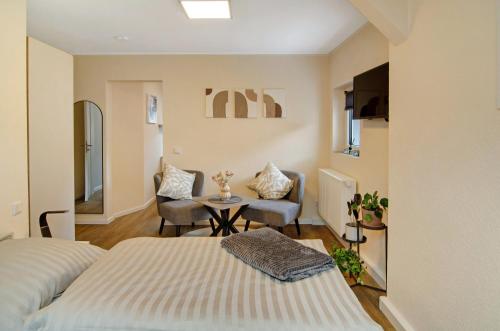 a bedroom with a bed and a table and a chair at Ferienhaus Berger 2025 in Bad Karlshafen