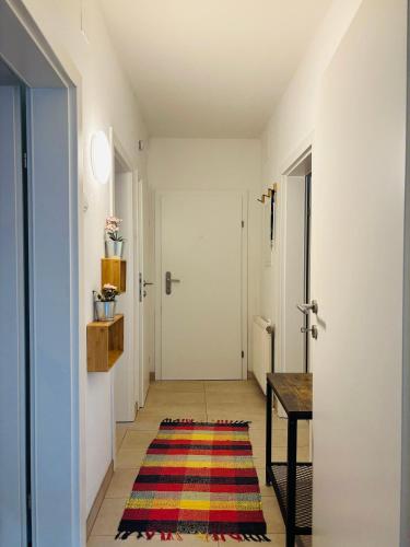 a hallway with a door and a rug at GARDEN AND LAKE Seenähe 1000m in Görtschach