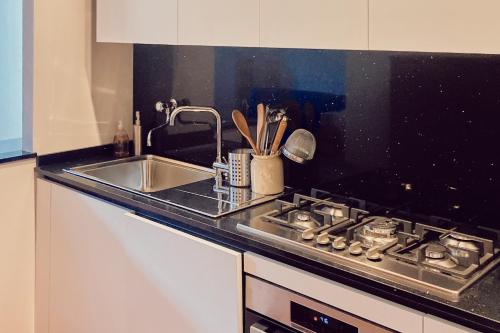 a kitchen counter with a sink and a stove at Agriturismo Fattoria Poggio di Fiesole in Fiesole