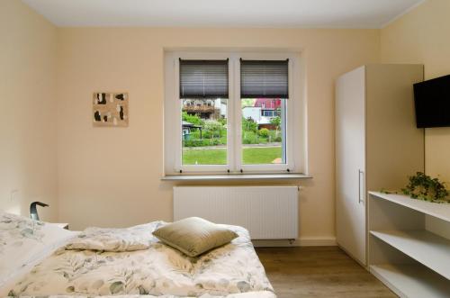 a bedroom with a bed and a window at Ferienhaus Berger 2025 in Bad Karlshafen