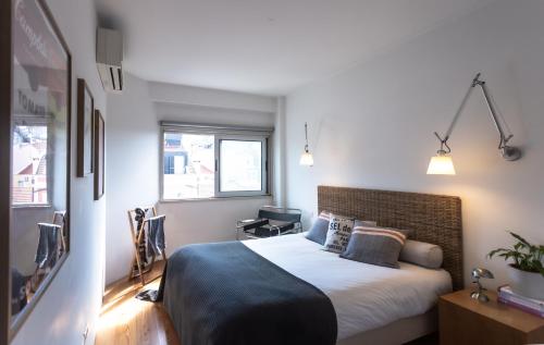 a bedroom with a large bed in a room at Design in Liberdade - 2 bedroom Apartment, Marquês Pombal in Lisbon