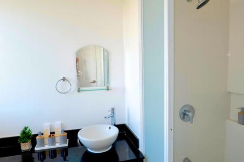 a bathroom with a white toilet and a mirror at W's Condo at One PonteFino Tower in Batangas City