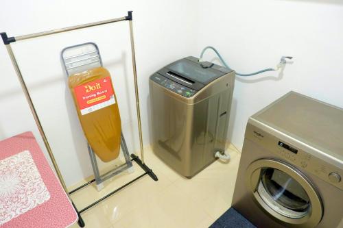 a laundry room with a washer and a washing machine at W's Condo at One PonteFino Tower in Batangas City