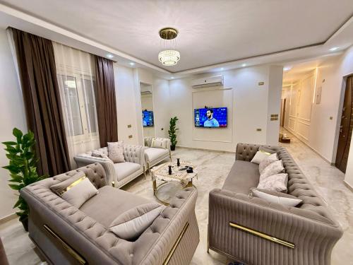 a large living room with couches and a tv at House in 6th Of October