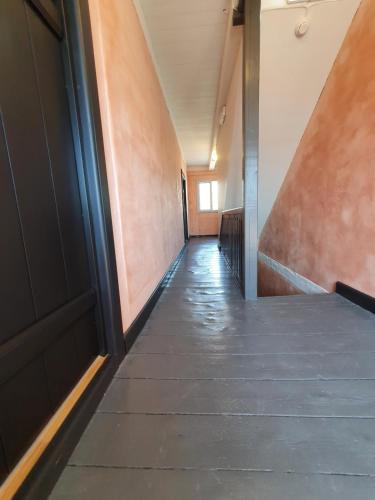 a hallway of an office building with a door at Garnisonsykehuset Stavern in Larvik