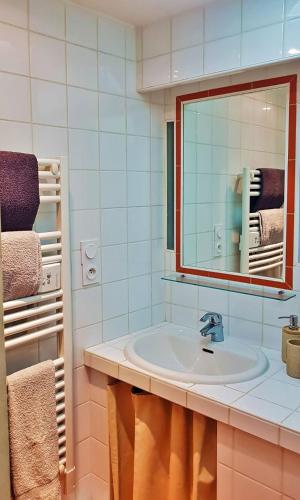 une salle de bain avec un lavabo, un miroir et des serviettes dans l'établissement Studio avec vue sur l'Amphithéâtre-arènes, à Arles