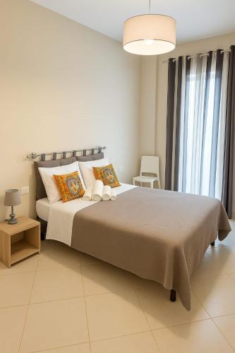 a bedroom with a large bed and a large window at SOGNO D'ESTATE 2 in Mazara del Vallo