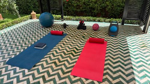 a carpet with two mats and a red carpet at Dar Tidyan Guest House - Ourika Valley in Igzi Ou Fella