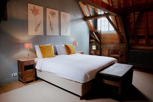 a bedroom with a large white bed with yellow pillows at Hotel Beijers in Utrecht