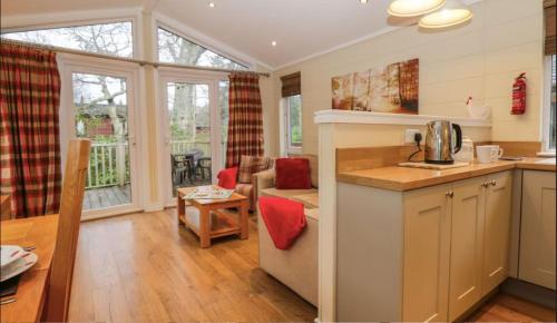 a kitchen and living room with a table at Brook Lodge in Troutbeck Bridge