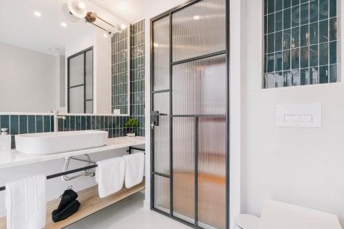 a bathroom with a sink and a mirror at Ototo Stylish Living in Thessaloniki