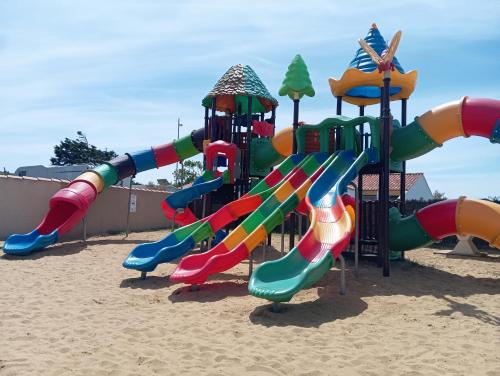 a playground with a slide in the sand at Sol à gogo 3 Chambres à 50 m de la plage in Saint-Hilaire-de-Riez