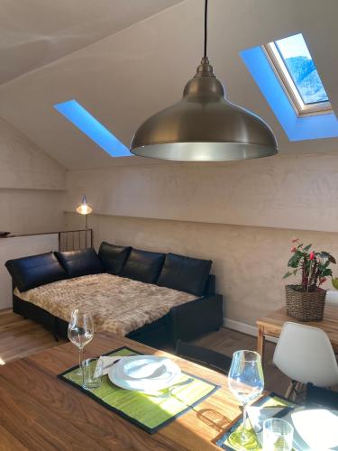 a living room with a bed and a table with glasses at Rustico Spontoi in Bellinzona