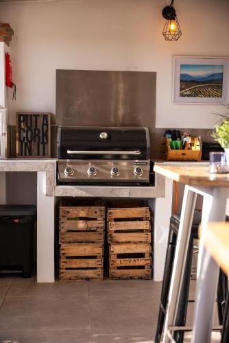 a kitchen with a grill and some wooden drawers at Finca Gran Cerros in Alora