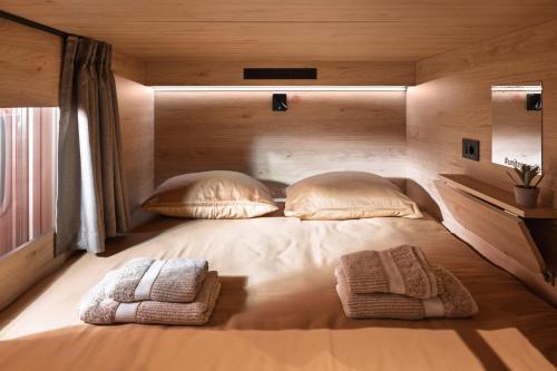 a large bed in a room with two pillows at U-NIGHT Hostel Budva in Budva