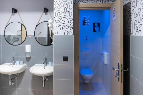 a bathroom with two sinks and a toilet at U-NIGHT Hostel Budva in Budva