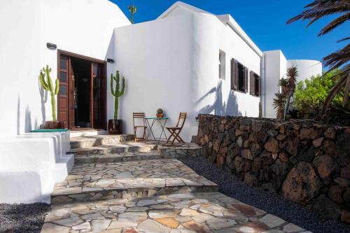 a white house with a stone walkway and a fence at Villa by the Sea in Mala