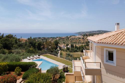 a villa with a pool and a view of the ocean at Hegemoni Villa Porto Heli in Porto Heli